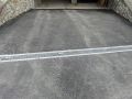 Stesura asfalto con canaletta prefabbricata in ferro zincato